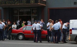 Police arrest a man after a fight outside the Men's Gallery.